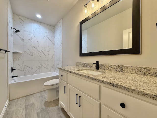 full bathroom with vanity, toilet, and tiled shower / bath