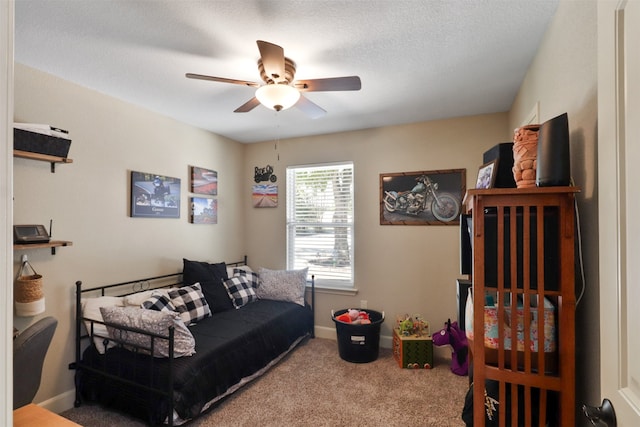 carpeted bedroom with a textured ceiling and ceiling fan