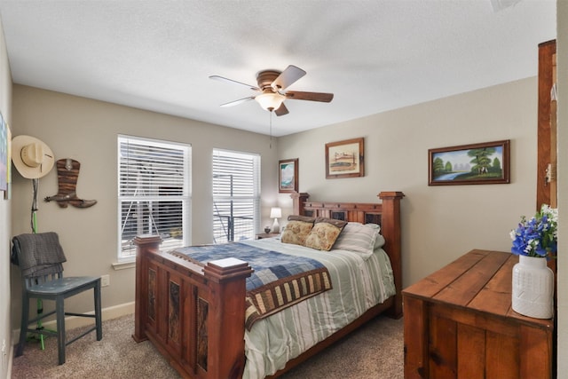 bedroom featuring light carpet, multiple windows, ceiling fan, and a textured ceiling