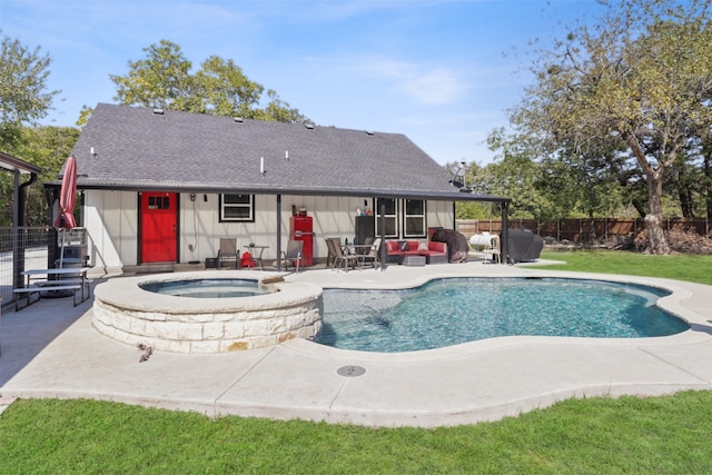 view of swimming pool with an in ground hot tub, a patio area, and a lawn