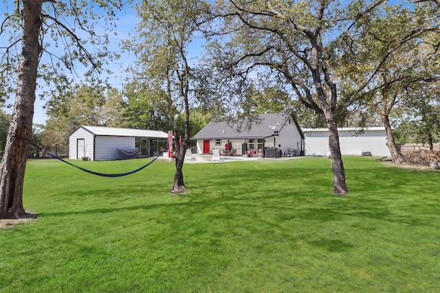 view of yard with an outdoor structure and a patio area