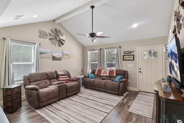 living room featuring ceiling fan, beam ceiling, a wealth of natural light, and dark hardwood / wood-style flooring