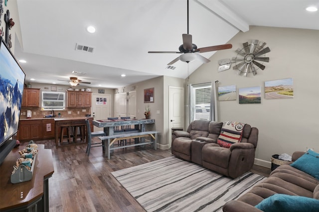 living room with dark hardwood / wood-style floors, beamed ceiling, sink, and ceiling fan