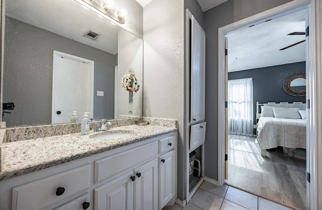 bathroom with tile patterned floors and vanity