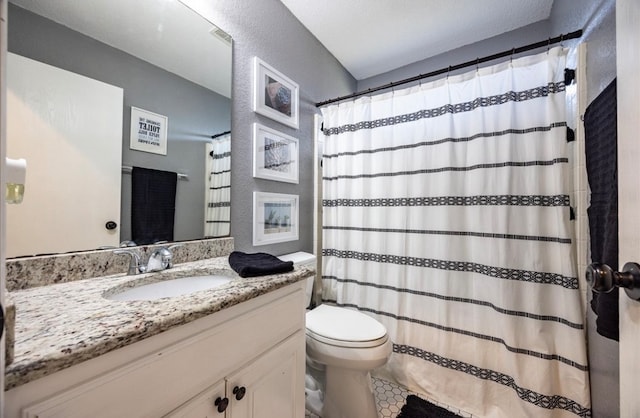 bathroom featuring a shower with curtain, vanity, toilet, and tile patterned floors