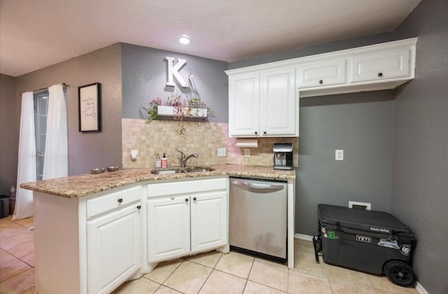 kitchen with white cabinets, sink, and stainless steel dishwasher