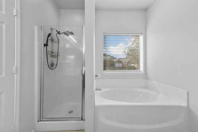 bathroom featuring separate shower and tub