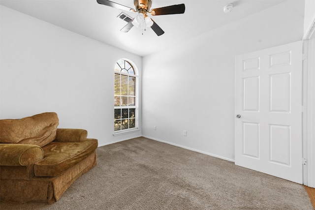 sitting room featuring carpet and ceiling fan