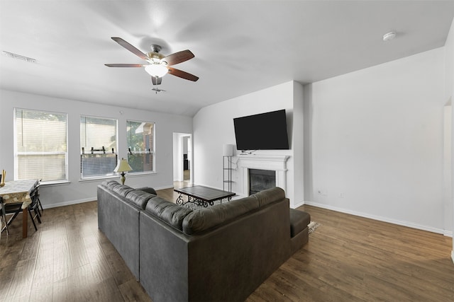 living room featuring ceiling fan and dark wood-type flooring