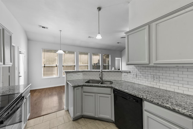 kitchen featuring sink, light hardwood / wood-style flooring, dishwasher, gray cabinets, and light stone countertops