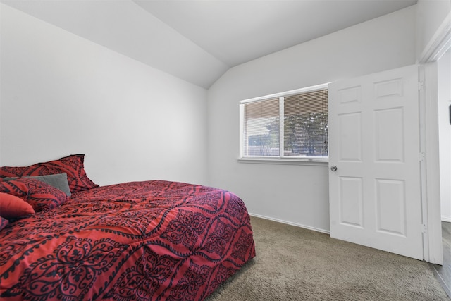 carpeted bedroom featuring vaulted ceiling