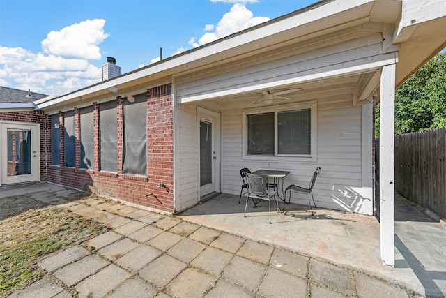 rear view of property featuring ceiling fan and a patio