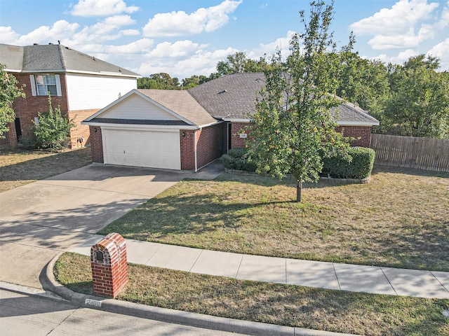 view of front facade with a front yard and a garage