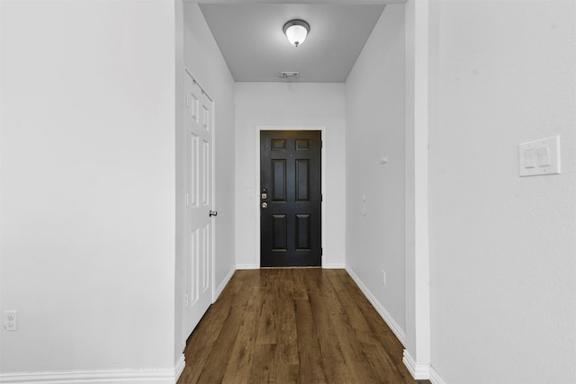 doorway with dark wood-type flooring