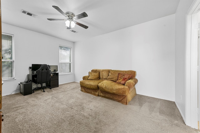 sitting room featuring ceiling fan and light colored carpet