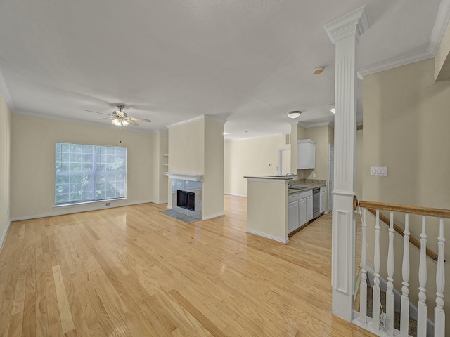 unfurnished living room featuring ornamental molding, light hardwood / wood-style flooring, and a high end fireplace