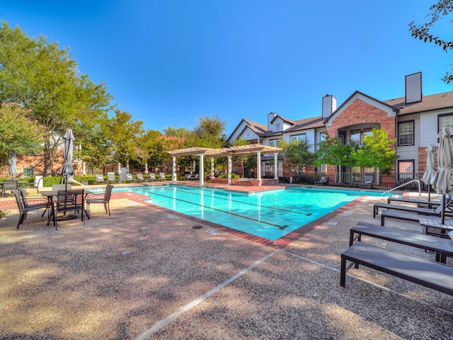 view of swimming pool featuring a pergola and a patio area