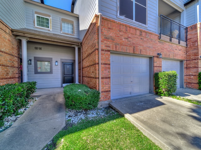 doorway to property with a balcony and a garage