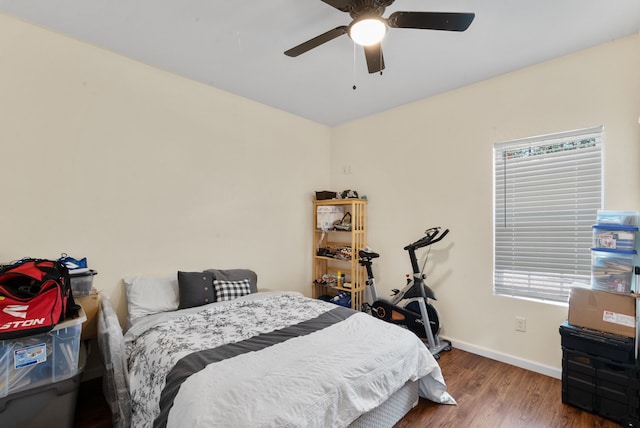 bedroom with dark hardwood / wood-style floors and ceiling fan