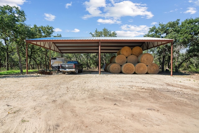 view of parking / parking lot featuring a carport