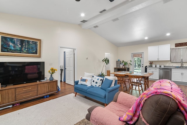 living room with vaulted ceiling with beams, dark hardwood / wood-style floors, and sink