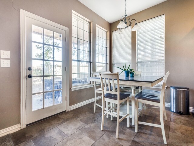 dining space with a chandelier and tile patterned floors