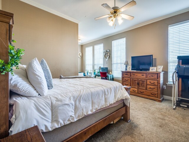 carpeted bedroom featuring ceiling fan and ornamental molding