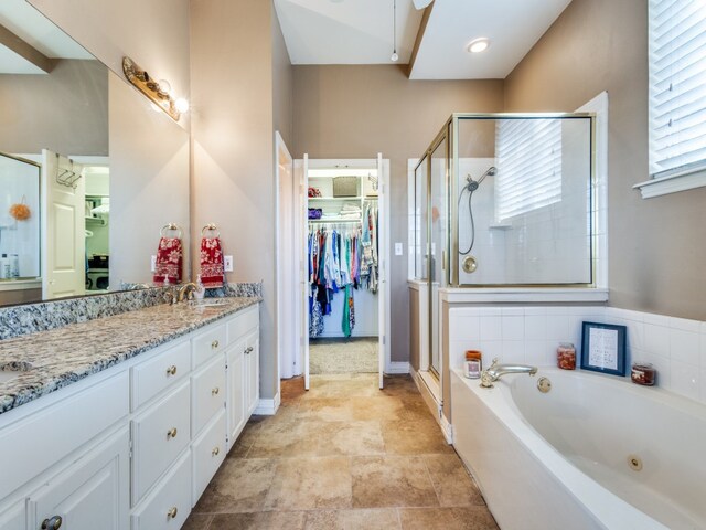 bathroom featuring vanity and independent shower and bath