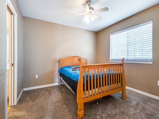 bedroom featuring ceiling fan and dark colored carpet