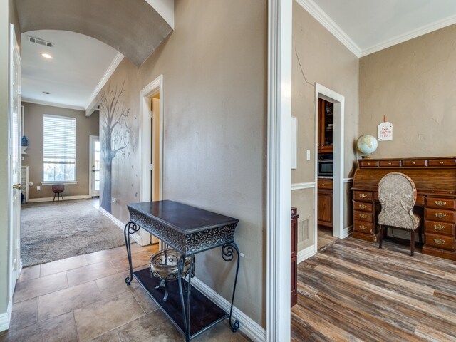 hall with crown molding and hardwood / wood-style flooring