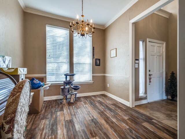 interior space featuring ornamental molding, dark wood-type flooring, and an inviting chandelier