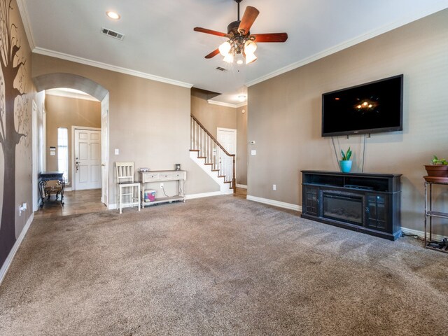 unfurnished living room featuring ceiling fan, crown molding, and carpet flooring