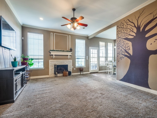 living room with ceiling fan, crown molding, and carpet