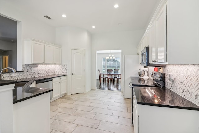 kitchen featuring an inviting chandelier, sink, stainless steel appliances, and white cabinets