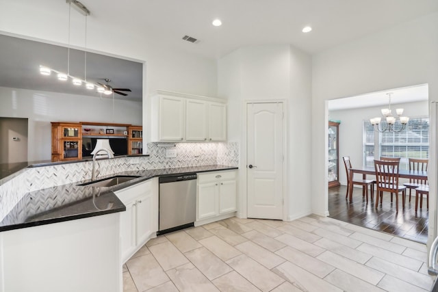 kitchen with decorative light fixtures, dishwasher, sink, backsplash, and kitchen peninsula