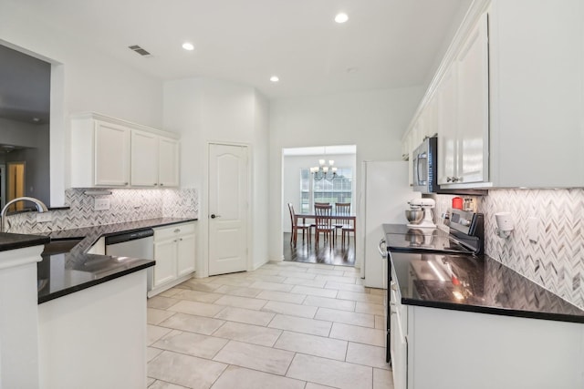 kitchen featuring a sink, dark countertops, white cabinets, and appliances with stainless steel finishes
