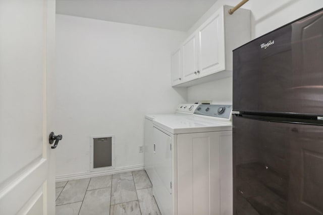 laundry room with separate washer and dryer and cabinets