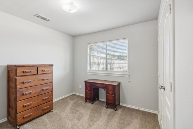 office space with baseboards, light colored carpet, and visible vents