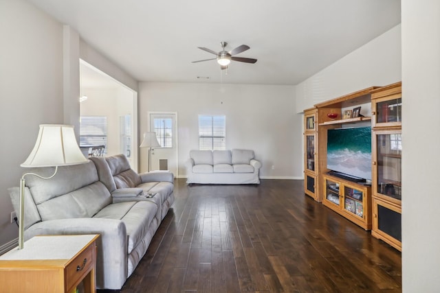 living room with baseboards, ceiling fan, and dark wood finished floors