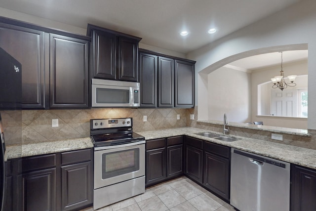 kitchen featuring tasteful backsplash, sink, appliances with stainless steel finishes, and a chandelier