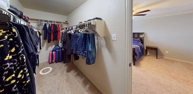 spacious closet with carpet flooring and ceiling fan