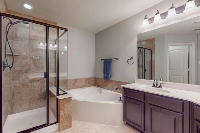 bathroom featuring vanity, shower with separate bathtub, a textured ceiling, and tile patterned flooring