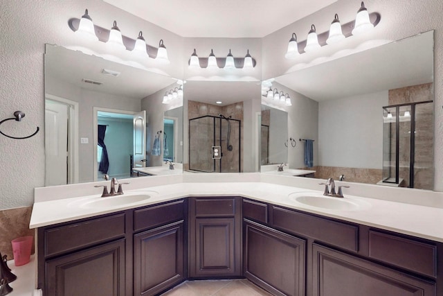 bathroom with tile patterned floors, vanity, and walk in shower