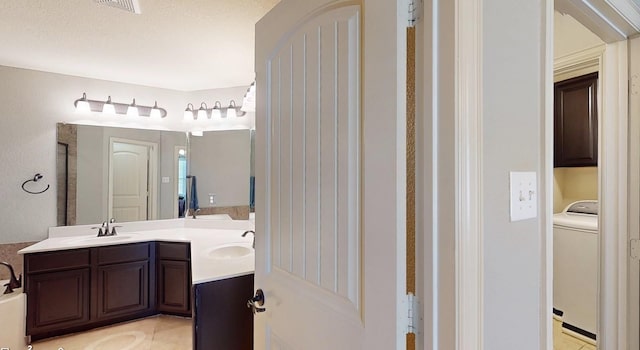 2924 Peyton Brook Dr, Fort Worth, TX 76137 - full bathroom with washer / clothes dryer, double vanity, visible vents, and a sink