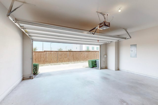 garage featuring electric panel and a garage door opener