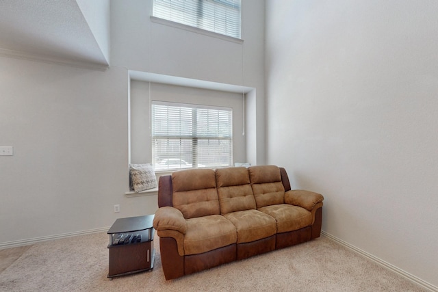 living room featuring light carpet and a high ceiling