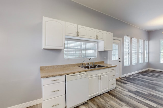 kitchen featuring dishwasher, light hardwood / wood-style floors, sink, and white cabinetry