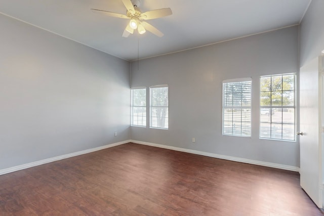 spare room featuring ceiling fan and dark wood-type flooring