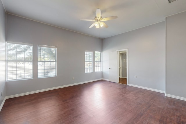 empty room with dark wood-type flooring and ceiling fan