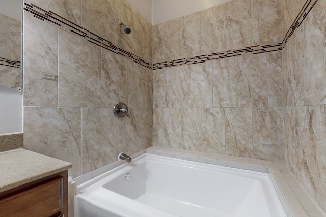 bathroom with vanity and tiled shower / bath